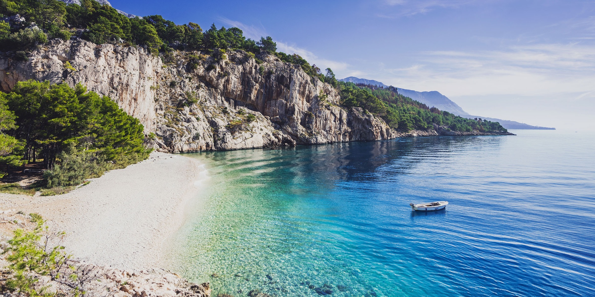 Nugal Beach — a hidden pebble cove backed by cliffs and pine forest near Makarska