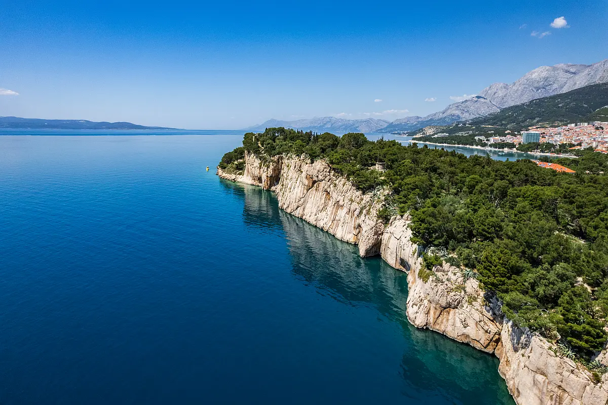 Aerial view of the Osejava peninsula in Makarska — pine-covered cliffs above the Adriatic