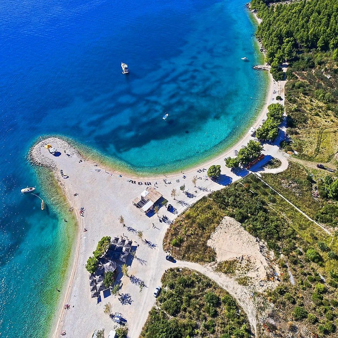 Aerial view of Ramova Beach near Makarska — a small pebble spit with clear turquoise water